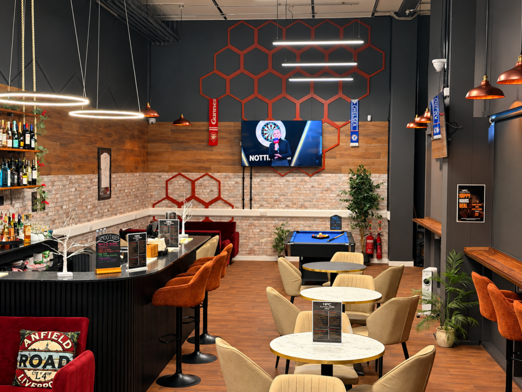 Warm lighting, comfortable seating, bar and pool table inside HPC Players Lounge