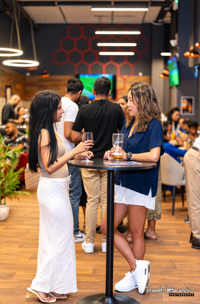 Friends chatting over drinks at HPC Players Lounge